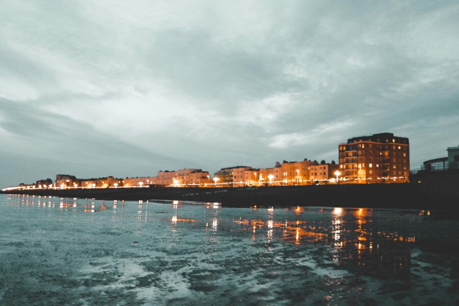 This picture shows a nighttime view of Worthing from the beach looking up to at the houses and hotesls.